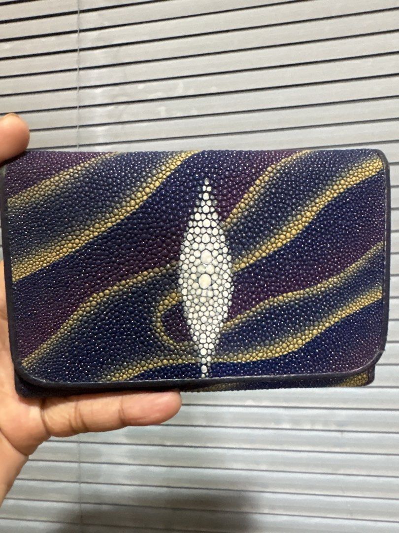Genuine Stingray Skin Wallet with Unique Pattern (Category: Wallets & Card holders) located in Cordova. Submitted by cb_bagz_n_bloom (Listing ID 1470304879, Image 1). Description: - Material: Genuine exotic stingray skin with a textured pebbled finish - Color/Design: Deep purple and navy base with metallic gold wave patterns - Distinctive Feature: Signature white pearl eye cluster centered on the front - Closure: Secure flap closure design - Cond