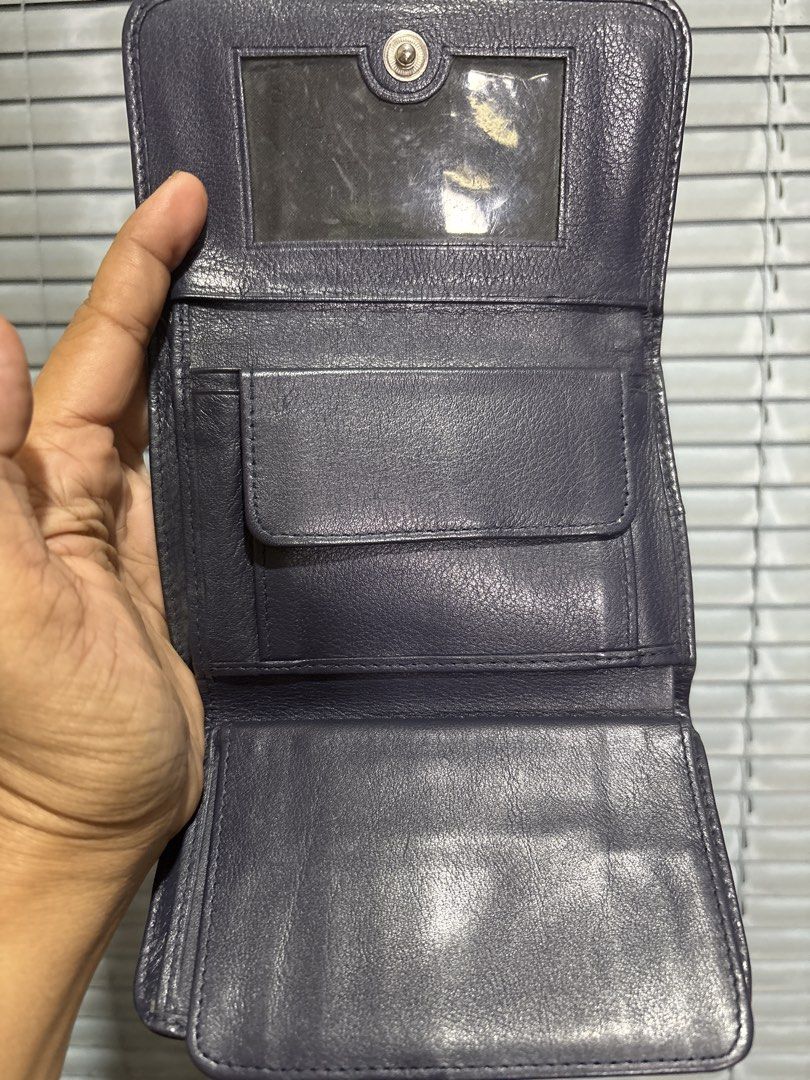 Genuine Stingray Skin Wallet with Unique Pattern (Category: Wallets & Card holders) located in Cordova. Submitted by cb_bagz_n_bloom (Listing ID 1470304879, Image 3). Description: - Material: Genuine exotic stingray skin with a textured pebbled finish - Color/Design: Deep purple and navy base with metallic gold wave patterns - Distinctive Feature: Signature white pearl eye cluster centered on the front - Closure: Secure flap closure design - Cond