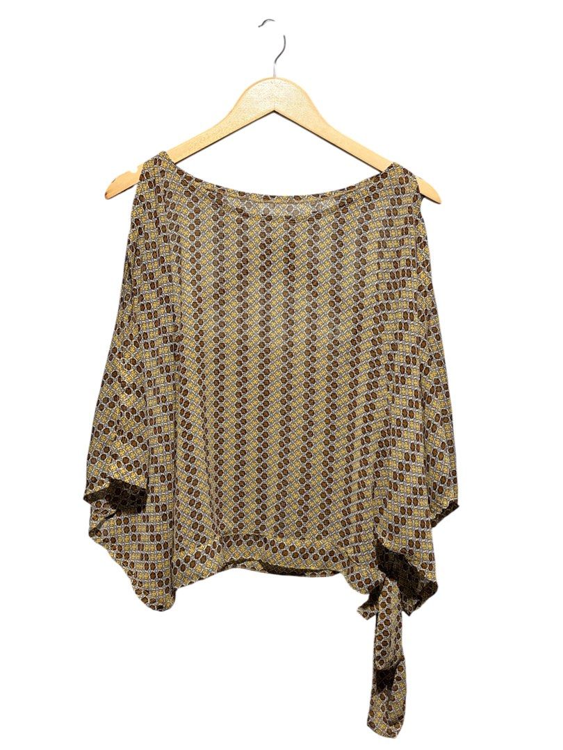 Geometric Pattern Short Sleeve Blouse with Side Tie (Category: Blouses) located in Cavite. Submitted by grandearth.39df3f (Listing ID 1470150655, Image 1). Description: - Design: Brown and yellow geometric print - Fit: Loose, flowy fit with a wide boat neckline and short draped off-the-shoulder sleeves - Detail: Attached side tie with a stylish cascading drape - Fabric: Lightweight and slightly sheer for a breezy feel - Styling: Perfect to pair c