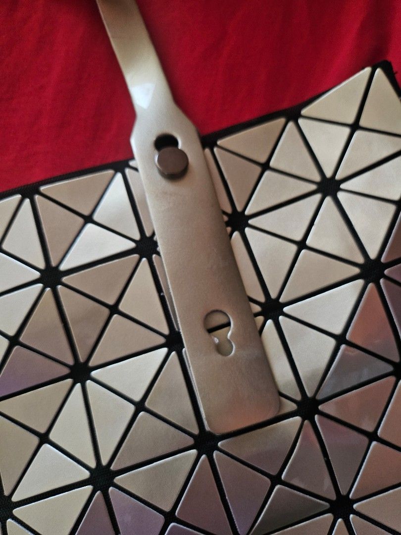 Geometric triangle tote bag silver gold metallic (Category: Tote Bags) located in Mandaluyong City. Submitted by ohwmaria (Listing ID 1470230263, Image 3). Description: - Futuristic silver and gold metallic tote bag with eye-catching geometric triangle panels - Flexible, lightweight structure that folds completely flat when empty - Spacious interior easily fits all your daily essentials - Dual top handles equipped with a snap closure detail - Con