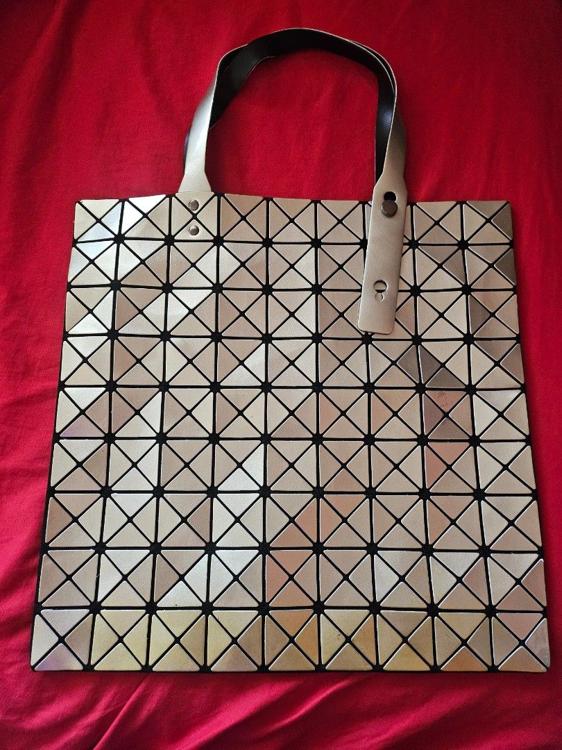 Geometric triangle tote bag silver gold metallic (Category: Tote Bags) located in Mandaluyong City. Submitted by ohwmaria (Listing ID 1470230263, Image 2). Description: - Futuristic silver and gold metallic tote bag with eye-catching geometric triangle panels - Flexible, lightweight structure that folds completely flat when empty - Spacious interior easily fits all your daily essentials - Dual top handles equipped with a snap closure detail - Con