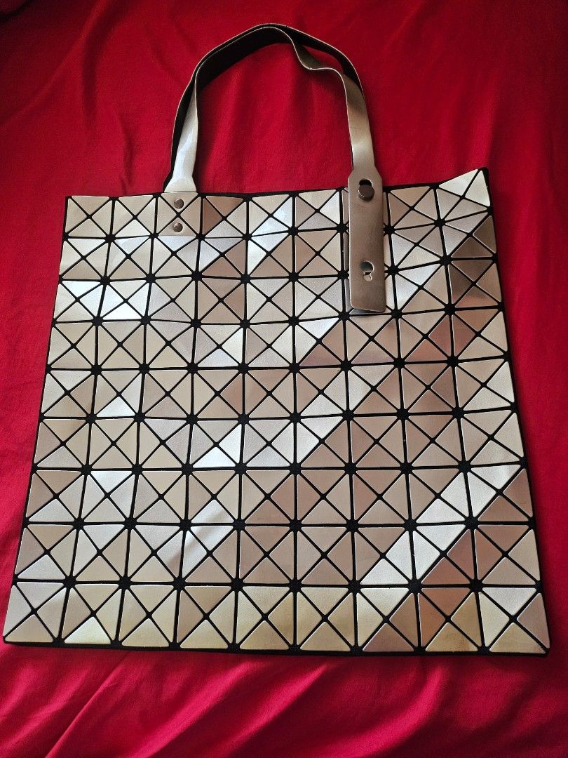 Geometric triangle tote bag silver gold metallic (Category: Tote Bags) located in Mandaluyong City. Submitted by ohwmaria (Listing ID 1470230263, Image 1). Description: - Futuristic silver and gold metallic tote bag with eye-catching geometric triangle panels - Flexible, lightweight structure that folds completely flat when empty - Spacious interior easily fits all your daily essentials - Dual top handles equipped with a snap closure detail - Con