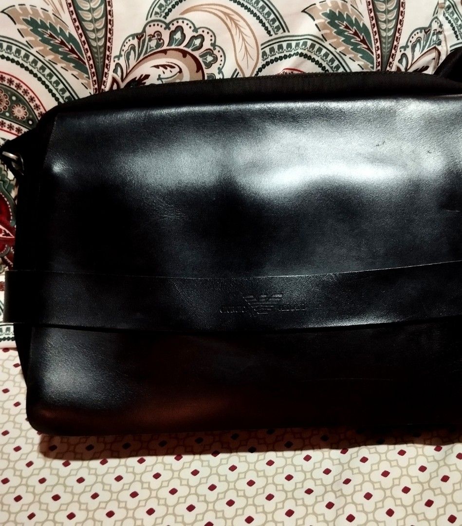 Giorgio Armani Black Leather Messenger Bag (Category: Sling Bags) located in Manila. Submitted by lene48 (Listing ID 1470283641, Image 1). Description: - Brand: Giorgio Armani - Material: Smooth black leather with durable fabric side panels - Design: Embossed brand logo on the front strap with stylish metal hardware - Convenience: Adjustable strap for a customized and comfortable fit - Style: Sleek and versatile messenger bag, ideal for work or c