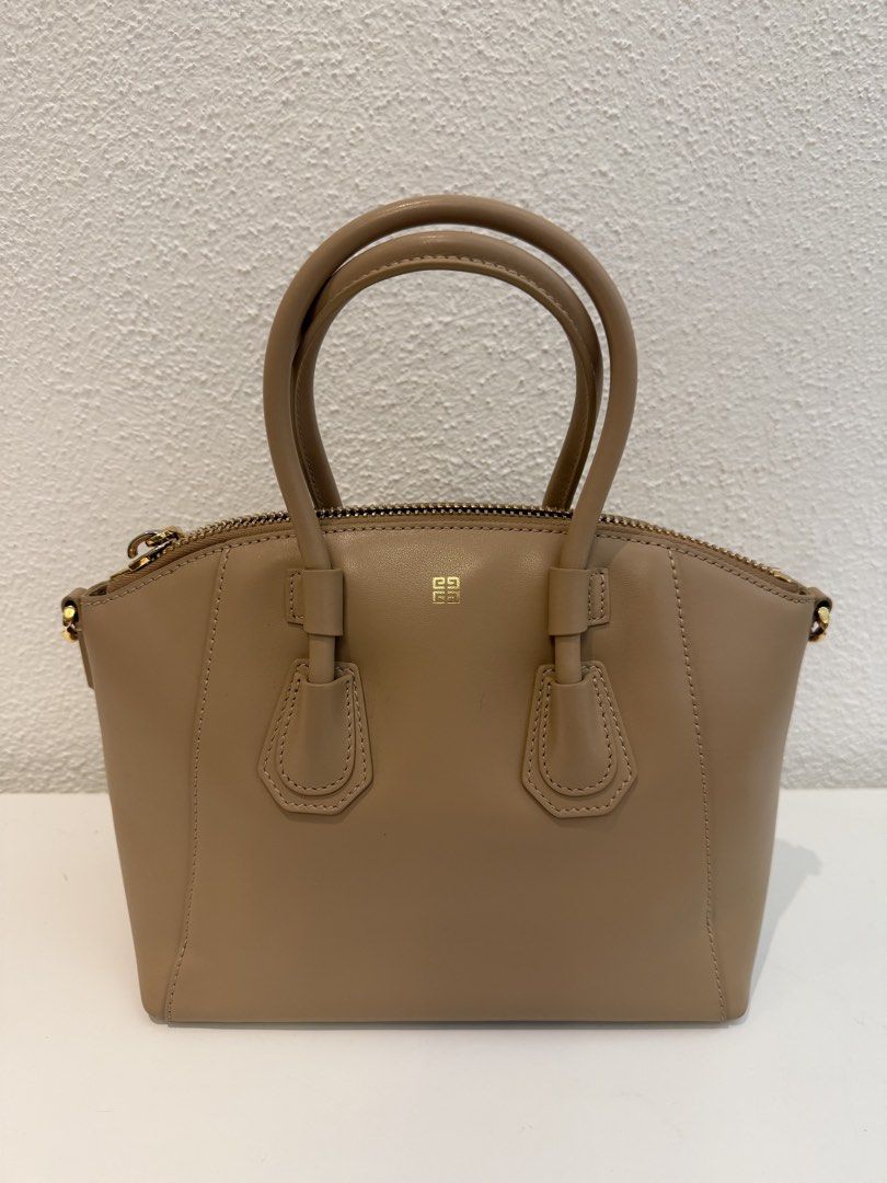 Givenchy Antigona Mini Leather Satchel Beige (Category: Luxury Bags & Wallets) located in Pasig City. Submitted by closetofashopaholic (Listing ID 1470243393, Image 3). Description: - Brand: Givenchy Antigona - Color: Classic Taupe with Gold-tone hardware - Material: Premium smooth leather - Inclusions: Dust bag, Original tag, and matching branded wide web shoulder strap - Condition: Pristine exterior and clean interior - Mode of Payment: GCash, 