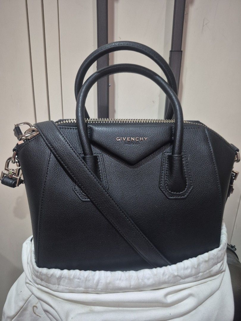 Givenchy Black Leather Antigona Handbag (Category: Luxury Bags & Wallets) located in Iloilo. Submitted by gorgeoustatz (Listing ID 1470289206, Image 2). Description: - Givenchy black leather handbag - Premium pebbled leather finish with sturdy stitching - Elegant gold-tone hardware and rolled top handles - Iconic triangular logo patch on the front - Secure double zip closure across the top - Includes original white dust bag - Condition: Excellent