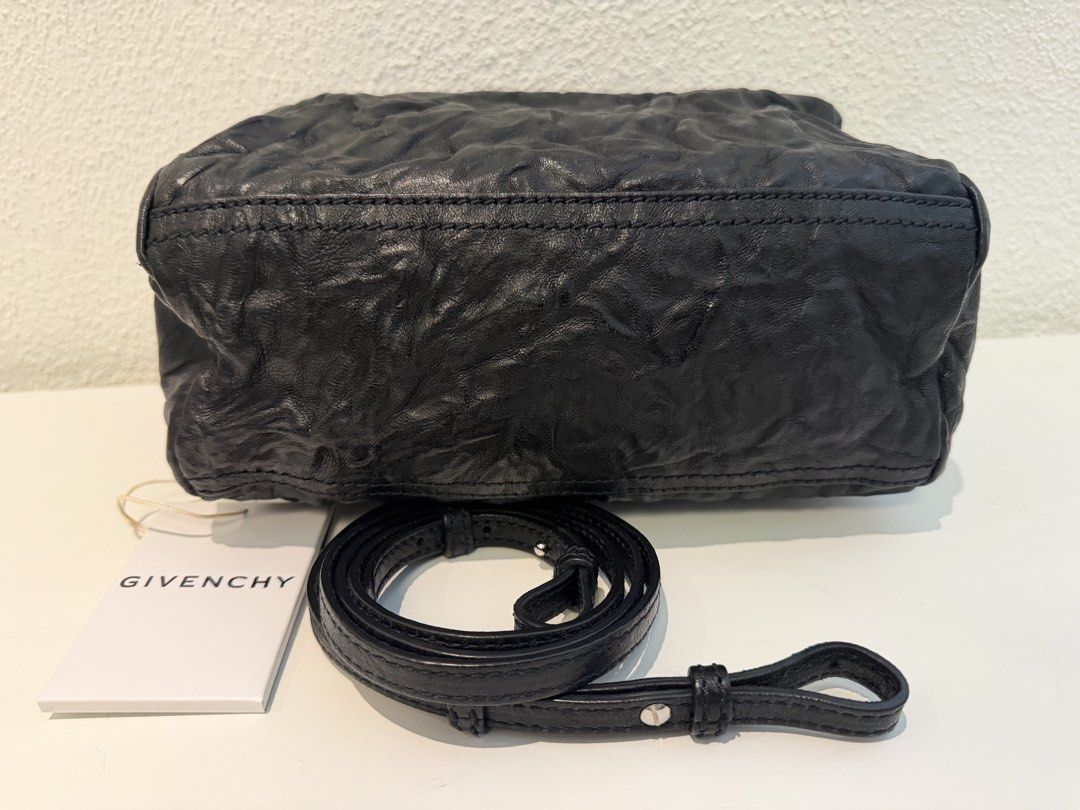 Givenchy Black Leather Crossbody Bag (Category: Luxury Bags & Wallets) located in Pasig City. Submitted by closetofashopaholic (Listing ID 1470242847, Image 3). Description: - Brand: Givenchy - Material: Black crinkled leather with silver-tone hardware - Details: Silver stamped logo on the front - Inclusion: Dust bag and original brand tag - Shape: Compact rectangular, versatile for everyday use or night outs - Condition: Excellent.