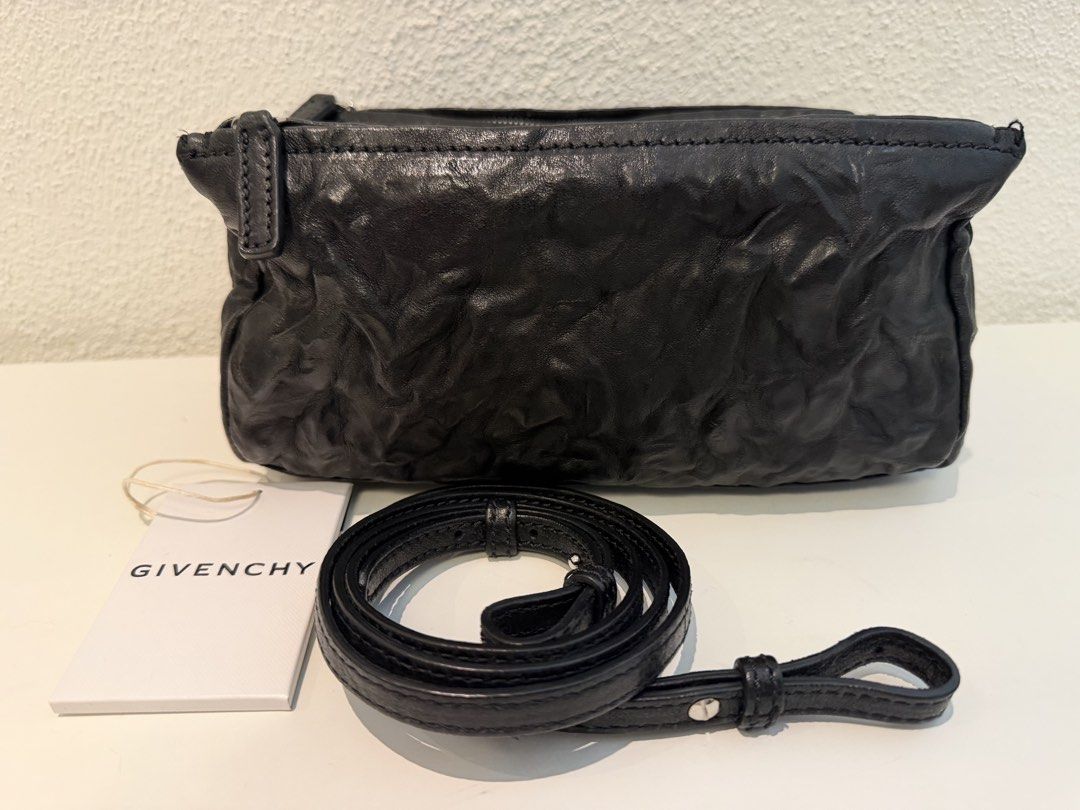 Givenchy Black Leather Crossbody Bag (Category: Luxury Bags & Wallets) located in Pasig City. Submitted by closetofashopaholic (Listing ID 1470242847, Image 2). Description: - Brand: Givenchy - Material: Black crinkled leather with silver-tone hardware - Details: Silver stamped logo on the front - Inclusion: Dust bag and original brand tag - Shape: Compact rectangular, versatile for everyday use or night outs - Condition: Excellent.