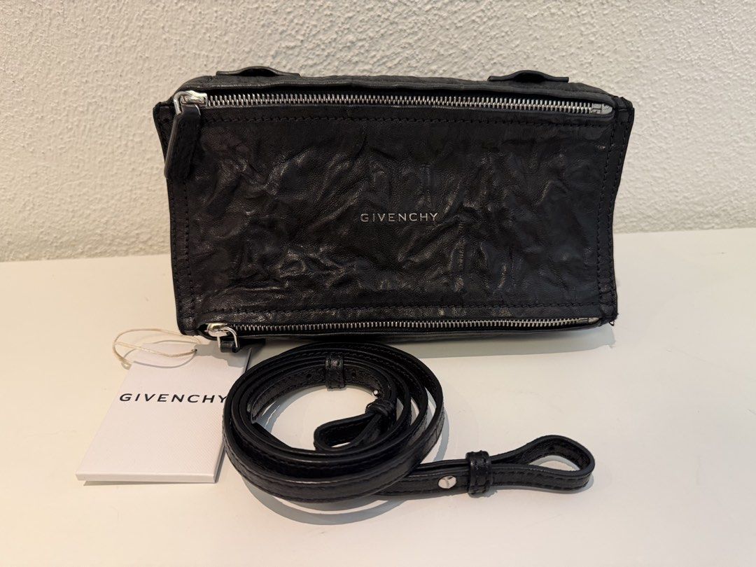 Givenchy Black Leather Crossbody Bag (Category: Luxury Bags & Wallets) located in Pasig City. Submitted by closetofashopaholic (Listing ID 1470242847, Image 1). Description: - Brand: Givenchy - Material: Black crinkled leather with silver-tone hardware - Details: Silver stamped logo on the front - Inclusion: Dust bag and original brand tag - Shape: Compact rectangular, versatile for everyday use or night outs - Condition: Excellent.
