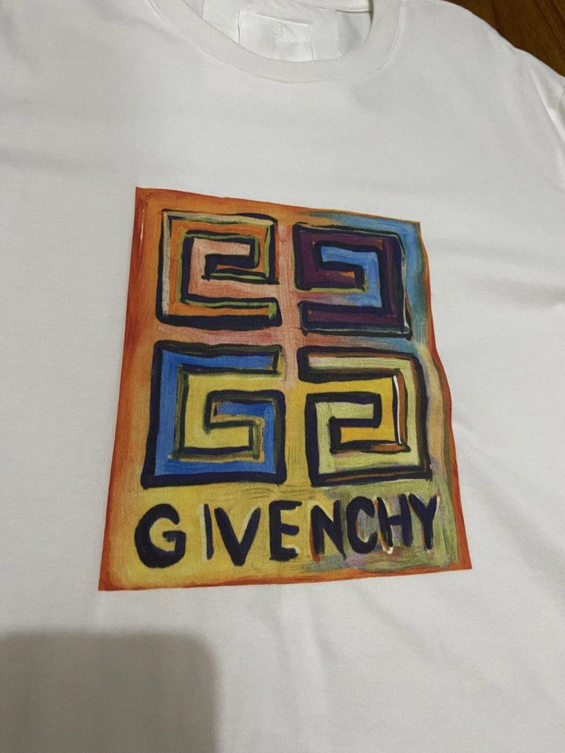 Givenchy Colorful Logo Graphic Tee Size S (Category: Shirts) located in Taguig. Submitted by maaarrrrrcky (Listing ID 1470264939, Image 2). Description: - Authentic Givenchy t-shirt in clean white cotton - Features a vibrant, painted-style graphic box logo on the chest - Classic crew neck and short sleeves - Size: S (verified by interior neck tags) - Condition: Excellent, clean, and ready to wear - Perfect for daily streetwear or casual outings -
