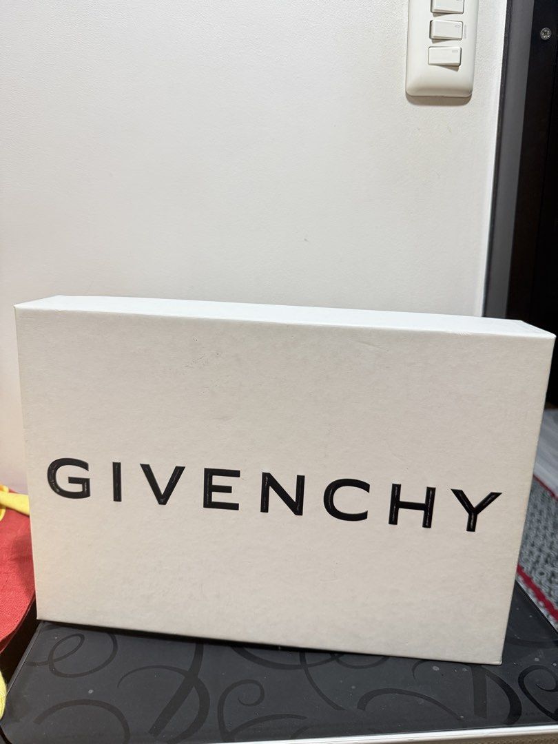 Givenchy White City Sneakers with Elastic Band (Category: Sneakers) located in Manila. Submitted by ktyyycloset (Listing ID 1470286515, Image 2). Description: - Brand: Givenchy - Color: White leather with bold black elastic strap - Features: White Givenchy branding on strap, metallic 4G logo hardware on tongue, and gold Givenchy lettering on heel counter - Inclusions: Original branded box included, dustbag and tags - Condition: Brand new with a m