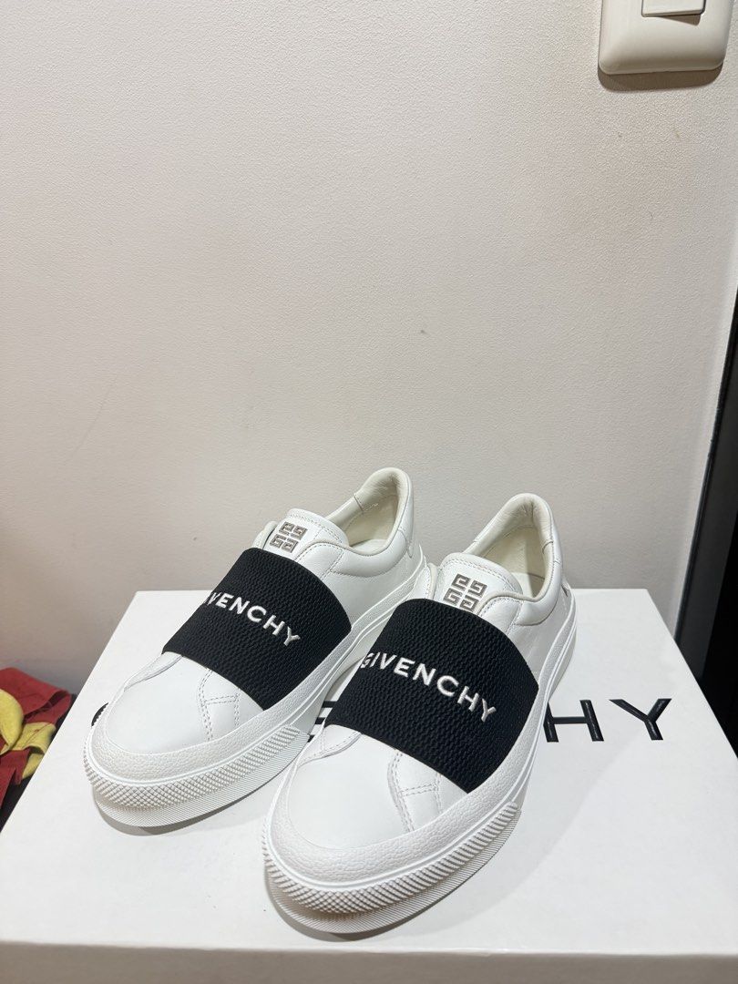 Givenchy White City Sneakers with Elastic Band (Category: Sneakers) located in Manila. Submitted by ktyyycloset (Listing ID 1470286515, Image 1). Description: - Brand: Givenchy - Color: White leather with bold black elastic strap - Features: White Givenchy branding on strap, metallic 4G logo hardware on tongue, and gold Givenchy lettering on heel counter - Inclusions: Original branded box included, dustbag and tags - Condition: Brand new with a m
