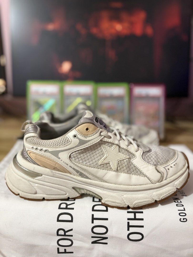 Golden Goose Lightstar Sneakers White Silver (Category: Sneakers) located in Las Pinas. Submitted by bujetbujit (Listing ID 1470344323, Image 1). Description: - Brand: Golden Goose - Model: lightstar - Colorway: White, silver, and tan accents - Design: Chunky silhouette, mesh panels, and signature side star - Details: Leather tongue and heel counter, embossed branding on back heel tab - Sole: Durable gum rubber outsole - Inclusion: Comes with bra