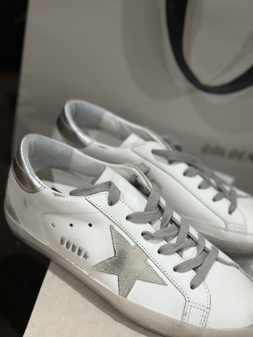 Golden Goose Superstar | Silver Star (Category: Sneakers & Footwear) located in Cebu City. Submitted by maeganllanos (Listing ID 1470201244, Image 2). Description: Golden Goose Super-Star sneakers in white with a silver star, grey laces, and metallic silver heel tab. Original price: 30,500 (Paris-bought in June 2025) Condition: Pre-loved, lightly worn since it’s not one of my go-to pairs Complete with original box and inclusions Price: ₱23,500, s