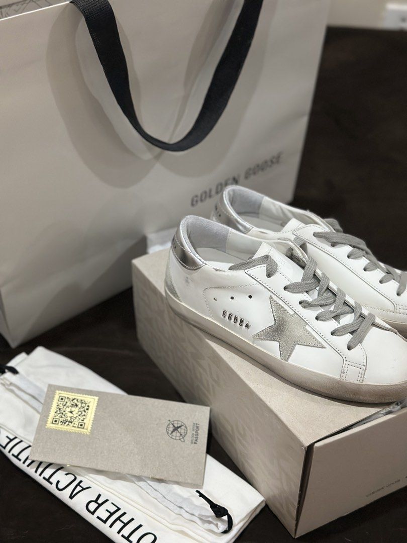 Golden Goose Superstar | Silver Star (Category: Sneakers & Footwear) located in Cebu City. Submitted by maeganllanos (Listing ID 1470201244, Image 1). Description: Golden Goose Super-Star sneakers in white with a silver star, grey laces, and metallic silver heel tab. Original price: 30,500 (Paris-bought in June 2025) Condition: Pre-loved, lightly worn since it’s not one of my go-to pairs Complete with original box and inclusions Price: ₱23,500, s