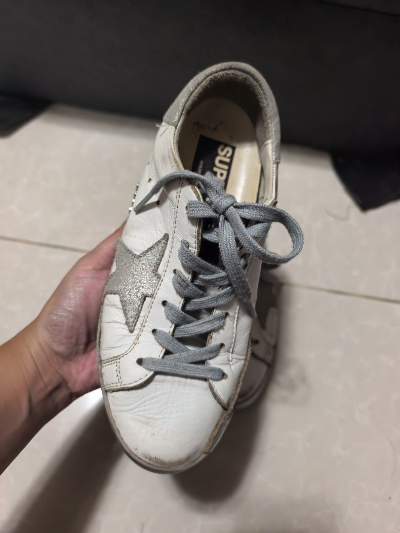 Golden Goose Super-Star Sneakers (Category: Sneakers) located in Roxas City. Submitted by tabet (Listing ID 1470294814, Image 2). Description: - Authentic Golden Goose sneakers in white leather - Iconic grey star and signature distressed finish - Classic grey laces and durable heavy-tread rubber soles - GGDB branding on the inside with Venezia tag - Mode of payment: BPI, BDO, or GCash - Shipping via LBC or Same-Day Delivery (Metro Manila).