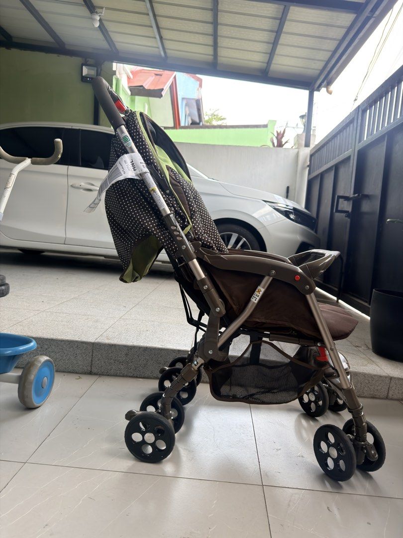 Goodbaby Brown Polka Dot Baby Stroller (Category: Strollers) located in Manila. Submitted by odddeer-364e (Listing ID 1470175978, Image 2). Description: - Stylish brown polka dot design with vibrant green accents - Adjustable canopy featuring a convenient mesh peekaboo window - Spacious under-seat storage basket for diaper bags and essentials - Comfortable padded headrest insert and secure harness straps - Smooth-rotating wheels ideal for everyda