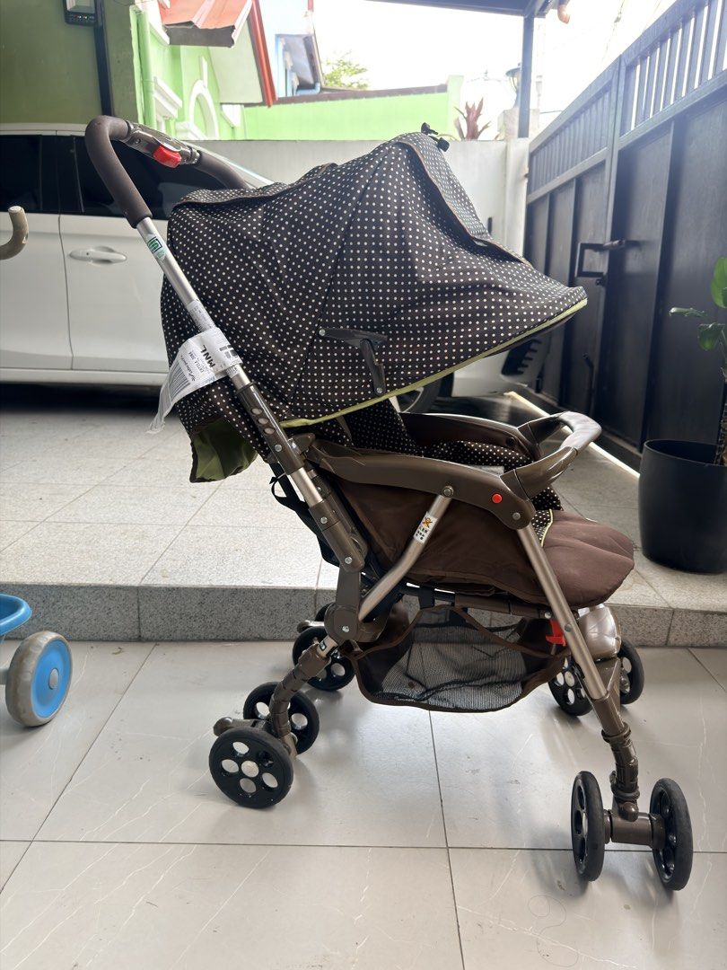 Goodbaby Brown Polka Dot Baby Stroller (Category: Strollers) located in Manila. Submitted by odddeer-364e (Listing ID 1470175978, Image 1). Description: - Stylish brown polka dot design with vibrant green accents - Adjustable canopy featuring a convenient mesh peekaboo window - Spacious under-seat storage basket for diaper bags and essentials - Comfortable padded headrest insert and secure harness straps - Smooth-rotating wheels ideal for everyda