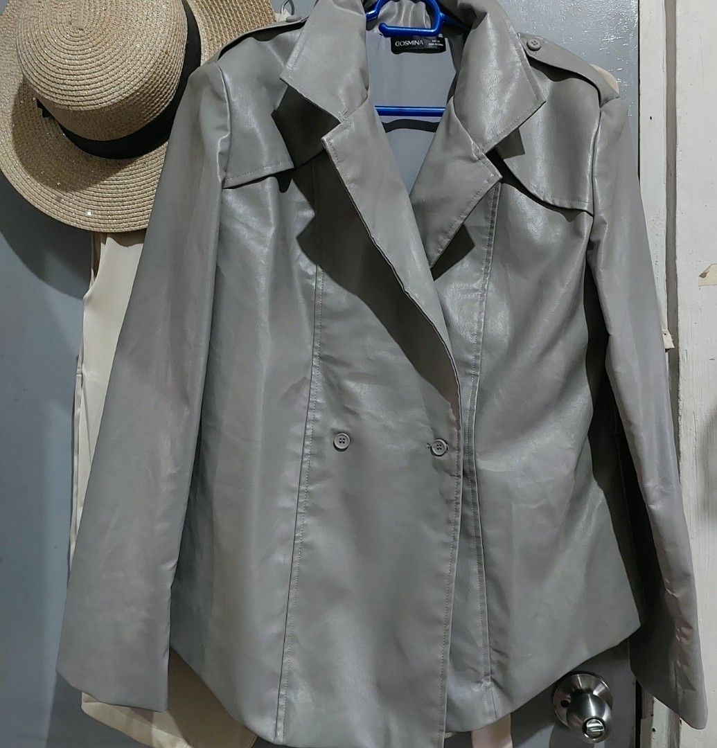 Gosmina Grey Faux Leather Trench Jacket Coat (Category: Coats, Jackets and Outerwear) located in Taguig. Submitted by hhhcherish (Listing ID 1470194708, Image 3). Description: - Brand: Gosmina - Style: Faux leather trench jacket in grey - Closure: Double-breasted front with buttons - Features: Lapel collar, shoulder epaulettes, and back storm flap - Interior: Smooth lining for comfortable layering - Perfect for: Cool weather layering UK Brand sup