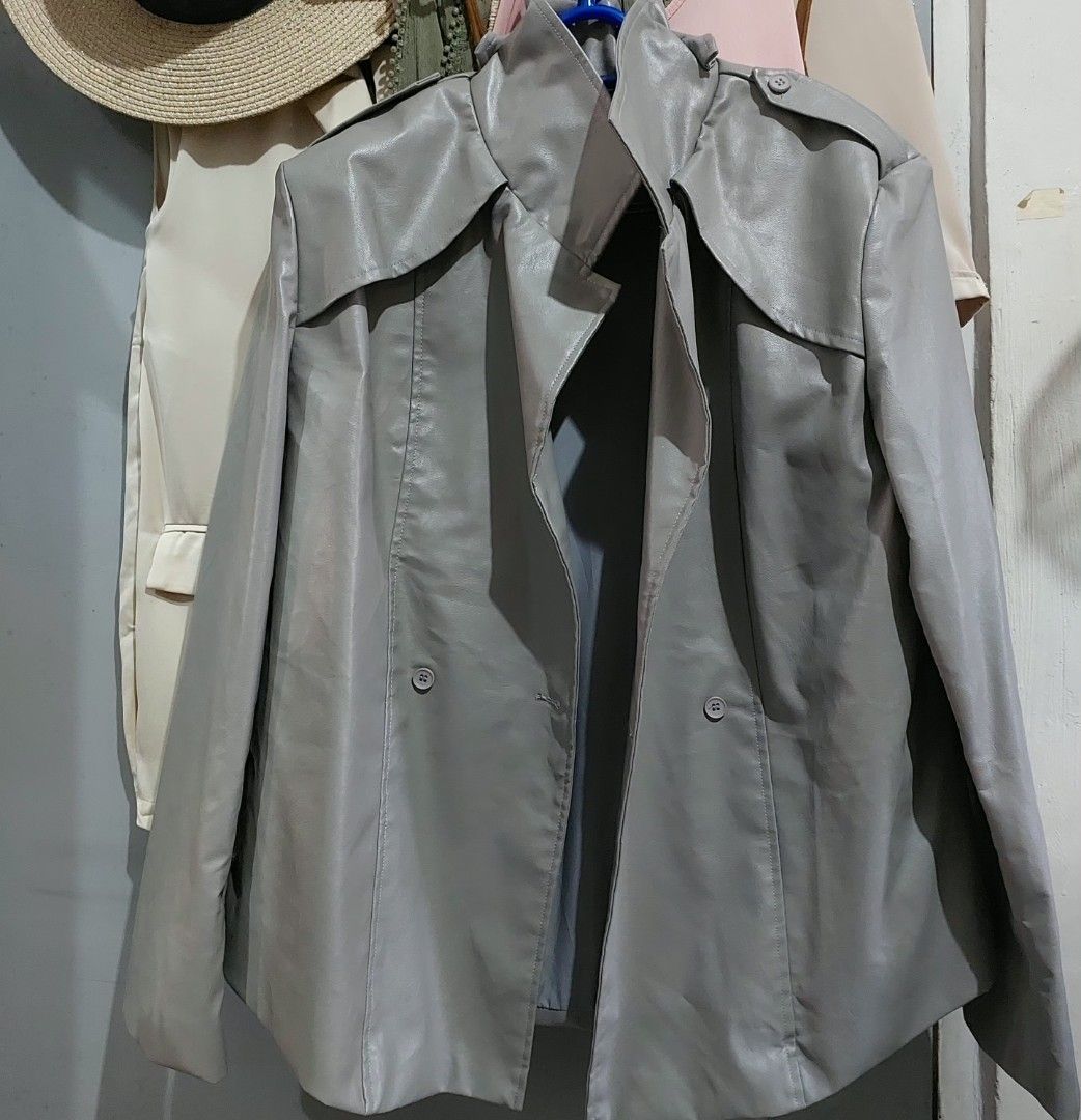 Gosmina Grey Faux Leather Trench Jacket Coat (Category: Coats, Jackets and Outerwear) located in Taguig. Submitted by hhhcherish (Listing ID 1470194708, Image 2). Description: - Brand: Gosmina - Style: Faux leather trench jacket in grey - Closure: Double-breasted front with buttons - Features: Lapel collar, shoulder epaulettes, and back storm flap - Interior: Smooth lining for comfortable layering - Perfect for: Cool weather layering UK Brand sup