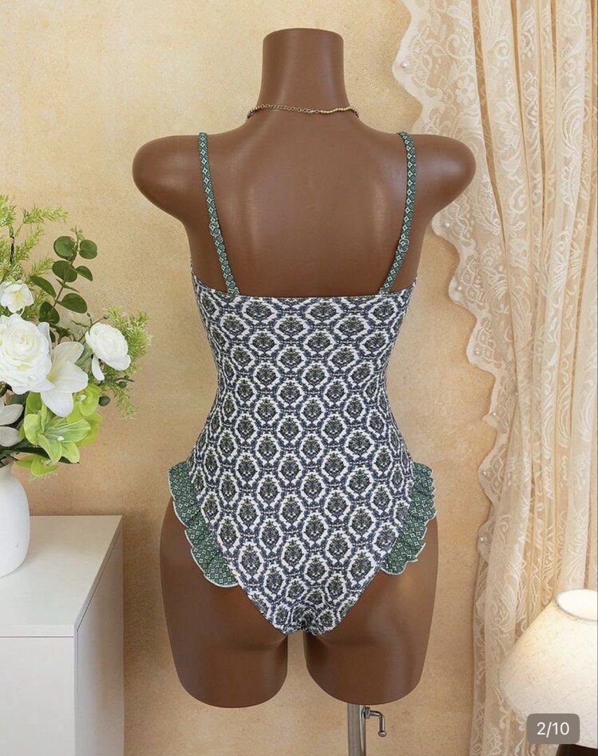 Green patterned one piece swimsuit with ruffles (Category: Bikinis & Swimsuits) located in Makati City. Submitted by gracebalms (Listing ID 1470242496, Image 2). Description: - Color/Pattern: Green and white patterned - Style: One-piece swimsuit with a slim fit and flattering silhouette - Neckline: V-notch neckline - Straps: Adjustable straps for a custom fit - Details: Cute ruffled trim along the leg openings - Condition: Clean and ready to wear