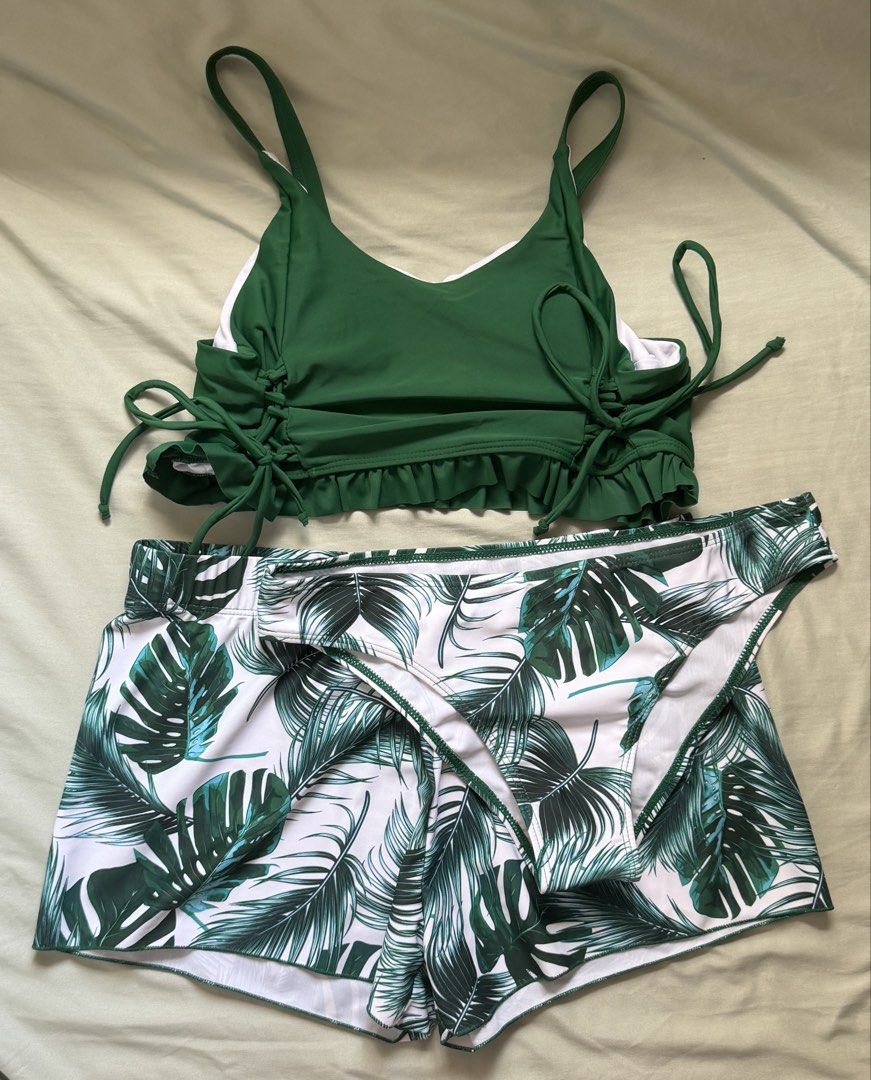 Green Tropical Palm Print Bikini Set Size M (Category: Bikinis & Swimsuits) located in Dinalupihan. Submitted by wonmeoww (Listing ID 1470252412, Image 1). Description: - 3-piece tropical swimwear set - Solid dark green bikini top with side ties and cute ruffled hem - Matching tropical leaf print bikini bottoms - Includes white and green leaf print boardshorts - Size: Medium.
