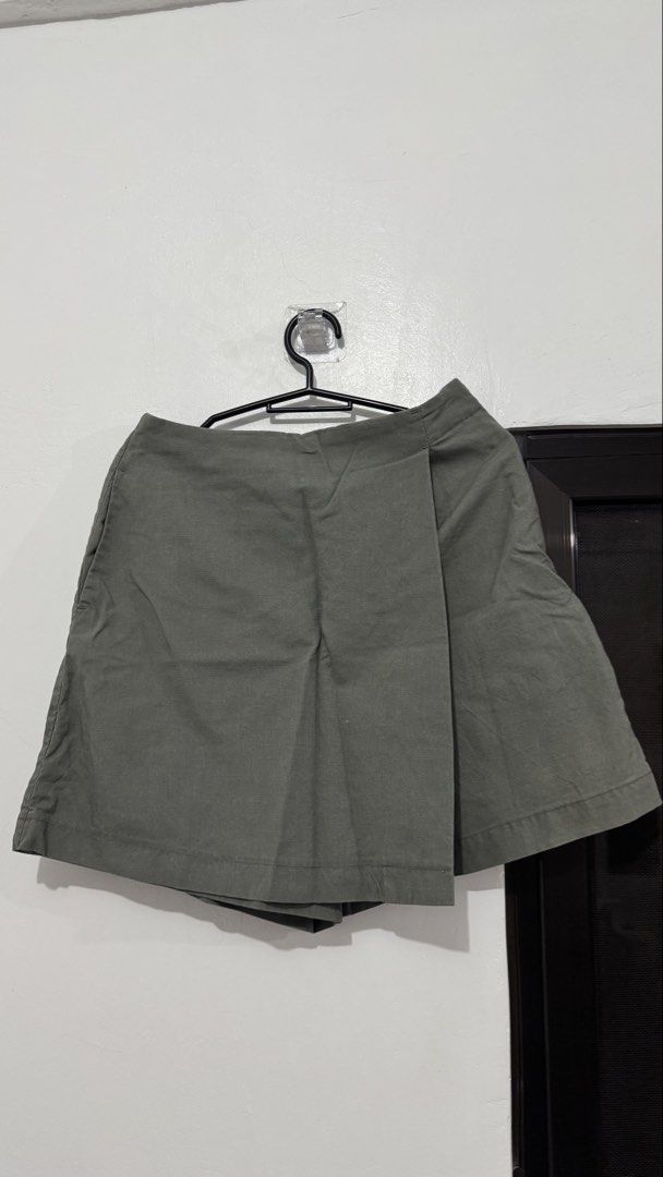 Green wrap skorts shorts skirt (Category: Skirts) located in Muntinlupa City. Submitted by maraaalpz (Listing ID 1470273549, Image 1). Description: - Color: Army green - Style: Wrap front skorts (skirt look with shorts comfort) - Waist: Mid-rise - Fabric: Sturdy, holds shape well - Styling: Easy to match with basic tees or crop tops - Condition: Clean and ready to wear.