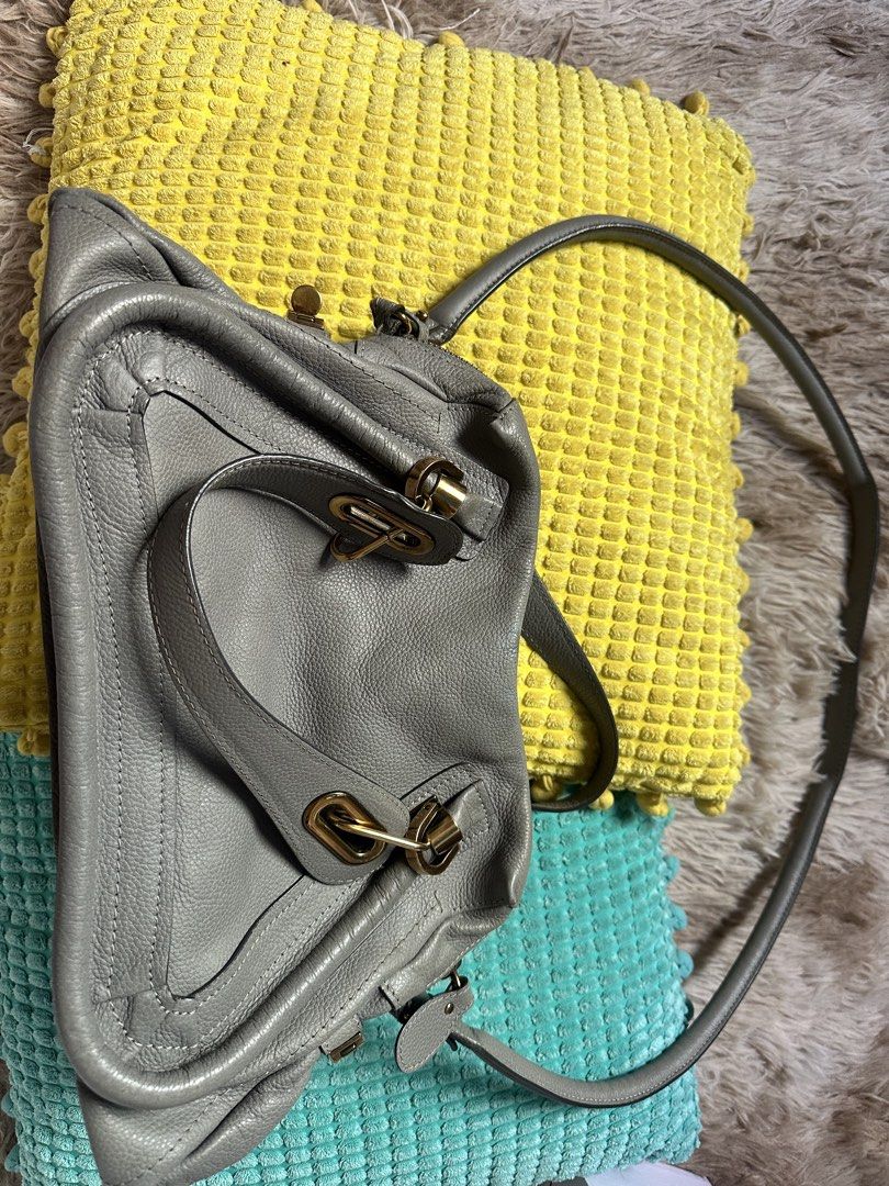 Grey Leather Shoulder Bag With Gold Hardware (Category: Luxury Bags & Wallets) located in Makati City. Submitted by ellen.mag (Listing ID 1470288671, Image 1). Description: Grey pebbled leather shoulder bag. Multiple structured compartments with gold-tone metal clasps and closures. Long adjustable strap attached on both sides. Soft slouchy body shape. Clean interior lining visible around the edges. Good storage capacity for daily essentials..