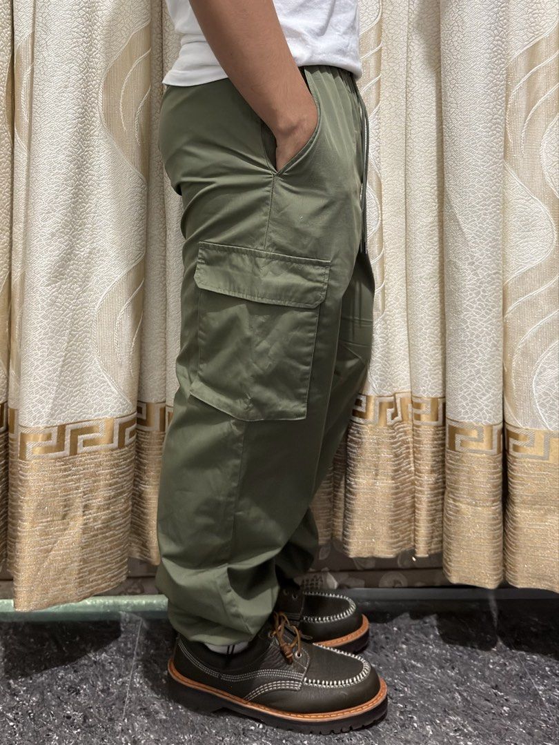 GU Olive Green Cargo Pants Size L (Category: Joggers) located in Guiguinto. Submitted by aries_ji (Listing ID 1470183856, Image 2). Description: - Brand/Model: GU Cargo Pants - Color: Olive Green - Size: Large - Material: 65% Polyester, 35% Cotton blend - Fit: Relaxed fit with gathered ankle cuffs - Waist: Elastic waistband with adjustable drawstring - Pockets: Multiple utility pockets on sides and back - Condition: Clean overall, perfect for str