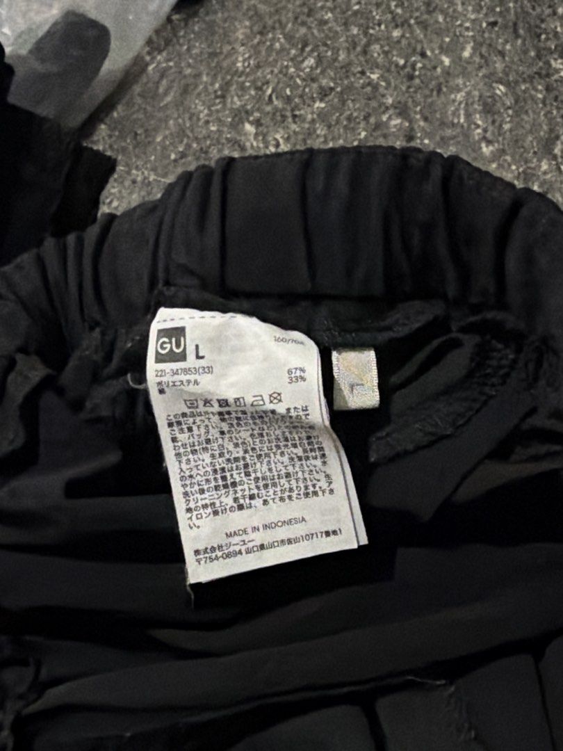 GU Personalized Black Butterfly Skull Cargo Pants Size L (Category: Joggers) located in Guiguinto. Submitted by aries_ji (Listing ID 1470254514, Image 2). Description: - Brand: GU - Size: L - Color: Black with striking white butterfly and skull graphics - Fit: Relaxed, wide-leg silhouette with elastic waistband - Material: 67% polyester, 33% cotton blend - Features: Multiple utility pockets for high functionality - Style: Trendy streetwear piece,