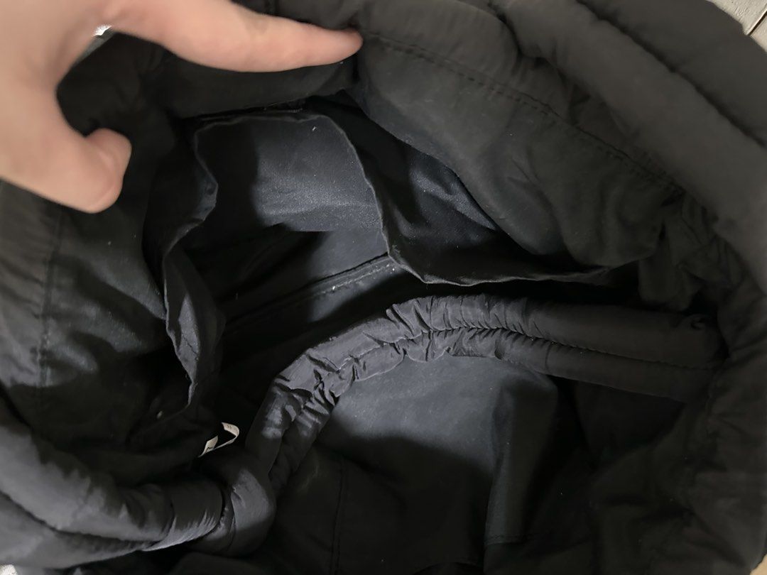 GU Puff Drawstring Bag (Black) (Category: Tote Bags) located in Quezon City. Submitted by monique29_ (Listing ID 1470215647, Image 3). Description: - Color: Black - Material: Lightweight nylon with quilted texture - Versatile wear: Soft padded handles and adjustable long strap for shoulder or crossbody use - Closure: Secure snap button main compartment - Storage: Roomy interior with smaller slip pockets for organization - Exterior: Two handy fron