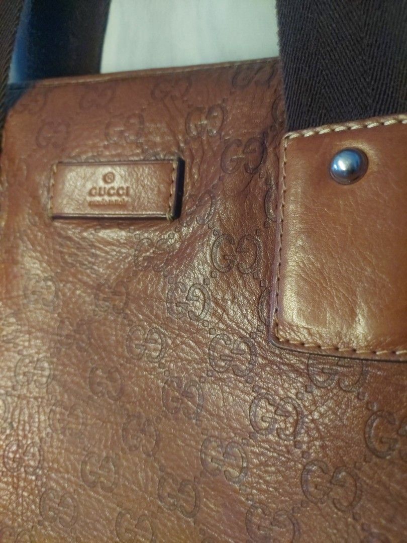 Gucci Brown Monogram Leather Tote Bag (Category: Luxury Bags & Wallets) located in Quezon City. Submitted by never_a_clutter (Listing ID 1470166565, Image 2). Description: - Authentic brown leather Gucci tote bag - All-over debossed GG monogram pattern - Durable dark brown fabric shoulder straps with leather attachment patches - Secure top zip closure (jacket type zipper) - Dark fabric interior lining - 1 interior zippered pocket and smaller slip