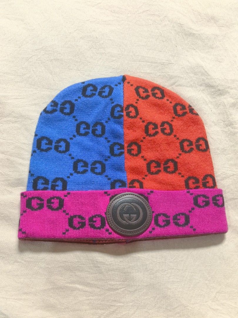 Gucci Colorblock GG Monogram Knit Beanie (Category: Hats & Beanies) located in Tacloban City. Submitted by thead.declutters (Listing ID 1470257169, Image 1). Description: - Brand: Gucci - Style: Colorblock knit beanie - Colors: Blue, red, and hot pink brim - Pattern: All-over black GG monogram - Details: Round leather Interlocking G patch on front cuff - Origin: Made in Italy (interior tag intact) - Condition: Great pre-loved condition - Perfect 