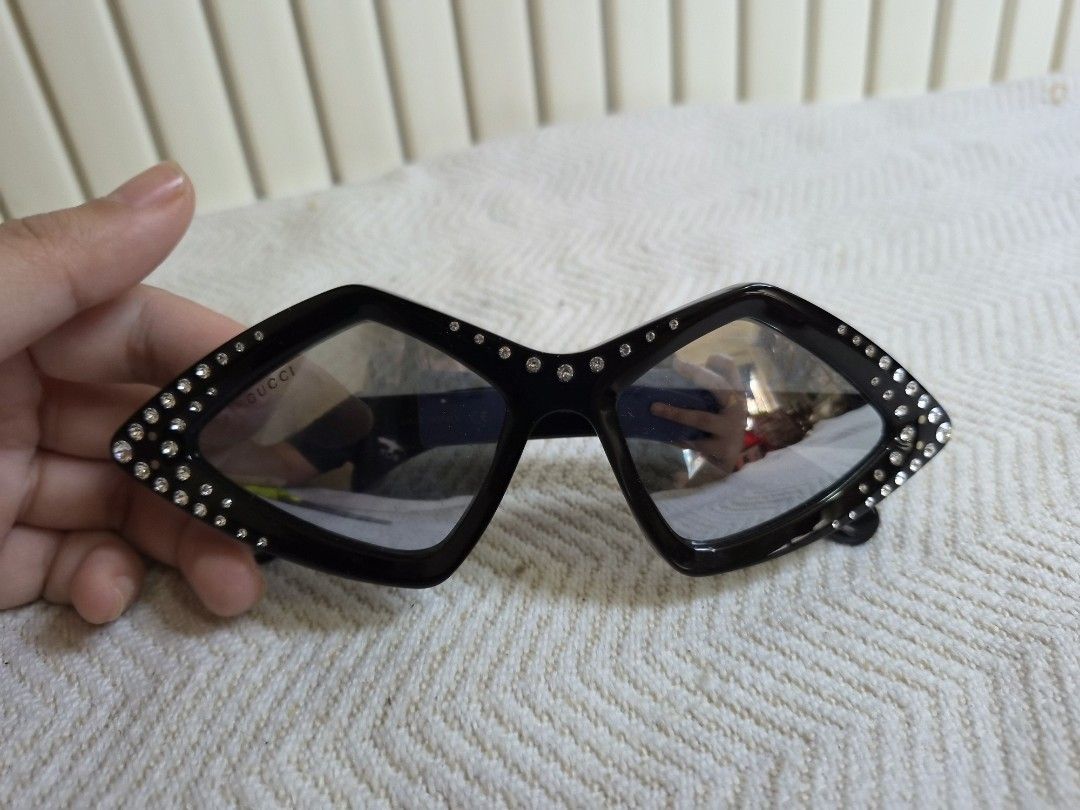 Gucci Diamond Rhinestone Sunglasses Black (Category: Sunglasses & Eyewear) located in Manila. Submitted by boldbear2001 (Listing ID 1470239528, Image 3). Description: - Brand: Gucci - Style: Diamond-shaped statement sunglasses - Color: Black with clear frames - Details: Sparkly rhinestones along the edges, branded lettering on lens and temple arms - Origin: Made in Italy - Condition: Excellent.