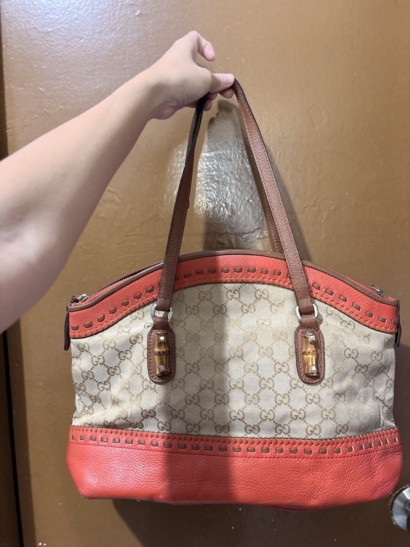 Gucci GG Canvas Bamboo Handle Tote Bag (Category: Tote Bags) located in Mandaluyong City. Submitted by gentle.segoviajam (Listing ID 1470230437, Image 2). Description: Gucci tote bag in beige GG canvas with coral pink leather trim. Bamboo details on the front strap rings. Dual brown leather shoulder handles. Zip top closure. Cream canvas interior lining includes a zippered pocket. Serial number stamped inside: 339002 1768..