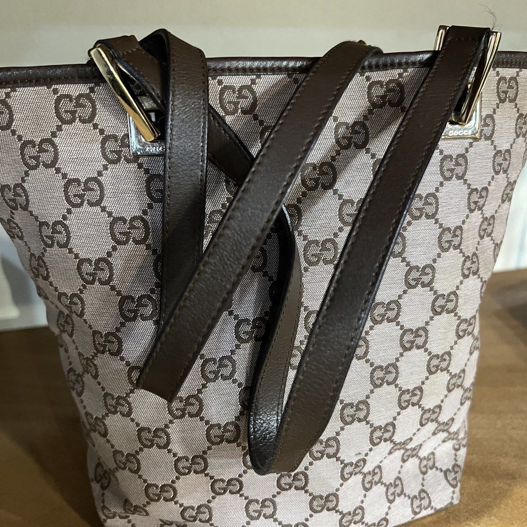 Gucci GG Canvas Tote Bag Brown (Category: Luxury Bags & Wallets) located in Binan City. Submitted by lovedbynins (Listing ID 1470230384, Image 2). Description: Authentic Gucci tote in classic brown GG monogram canvas with dark brown leather straps and gold hardware. Message me for the bag code. In good condition overall, with some signs of wear and there’s a minor stain inside the bag. Kindly check and zoom photos for details 😊 No inclusions..
