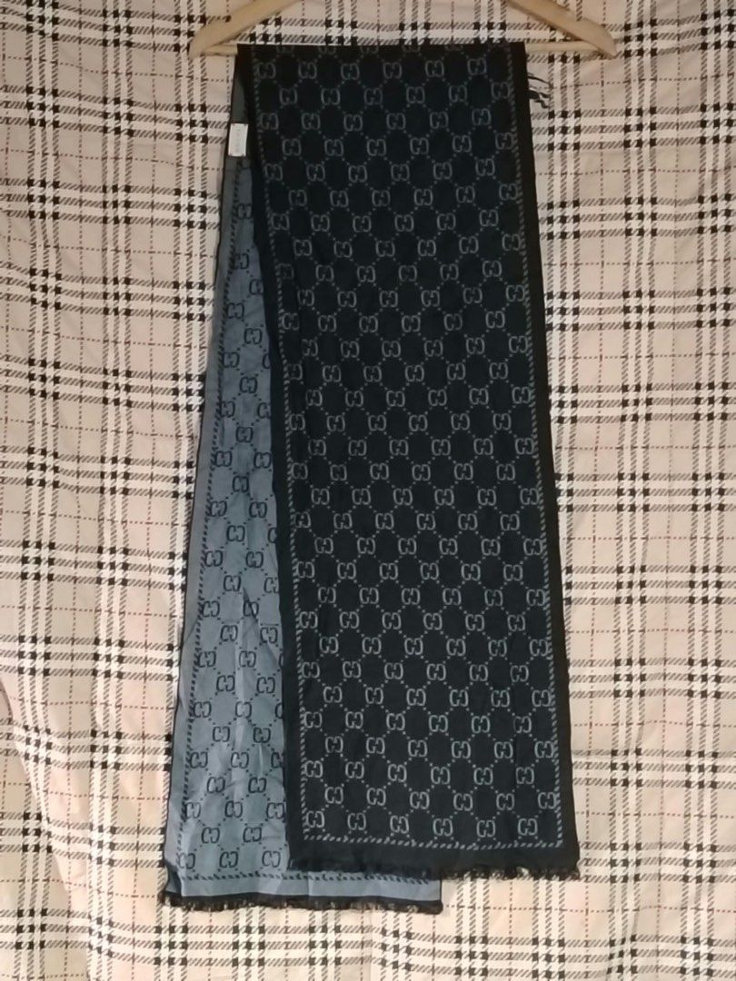 Gucci GG Monogram Silk Wool Scarf (Category: Scarves) located in Butuan. Submitted by natalday (Listing ID 1470166179, Image 2). Description: - Authentic Gucci designer scarf - Classic dark navy and light blue two-tone colorway - Iconic all-over interlocking G monogram pattern - Elegant fringe detailing on both ends - Lightweight and premium fabric for a luxurious drape - Perfect for elevating any outfit.