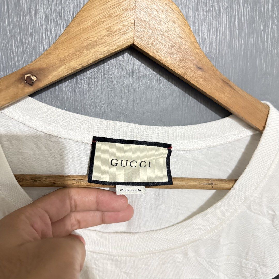Gucci Guccification Cat Sequin T-Shirt White (Category: Shirts) located in Manila. Submitted by preciousma24494 (Listing ID 1470261883, Image 2). Description: - Authentic Gucci statement t-shirt made in Italy size:Large - Premium soft white cotton with classic crew neck and short sleeves - Eye-catching large cat graphic on the front - Detailed with sparkly green sequin eyes and red sequin Guccification lettering - Includes full inside branding an