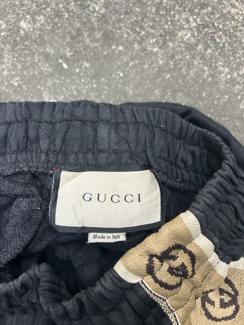 Gucci Interlocking G Side Stripe Jogging Shorts (Category: Shorts) located in Manila. Submitted by andotputla37237 (Listing ID 1470349036, Image 3). Description: - Brand: Designer (Made in Italy) - Size: S (Relaxed fit) - Material: Heavyweight black cotton fleece - Details: Beige & brown GG interlocking stripe tape on both sides - Features: White drawstring waistband & secure zip pockets on each side.