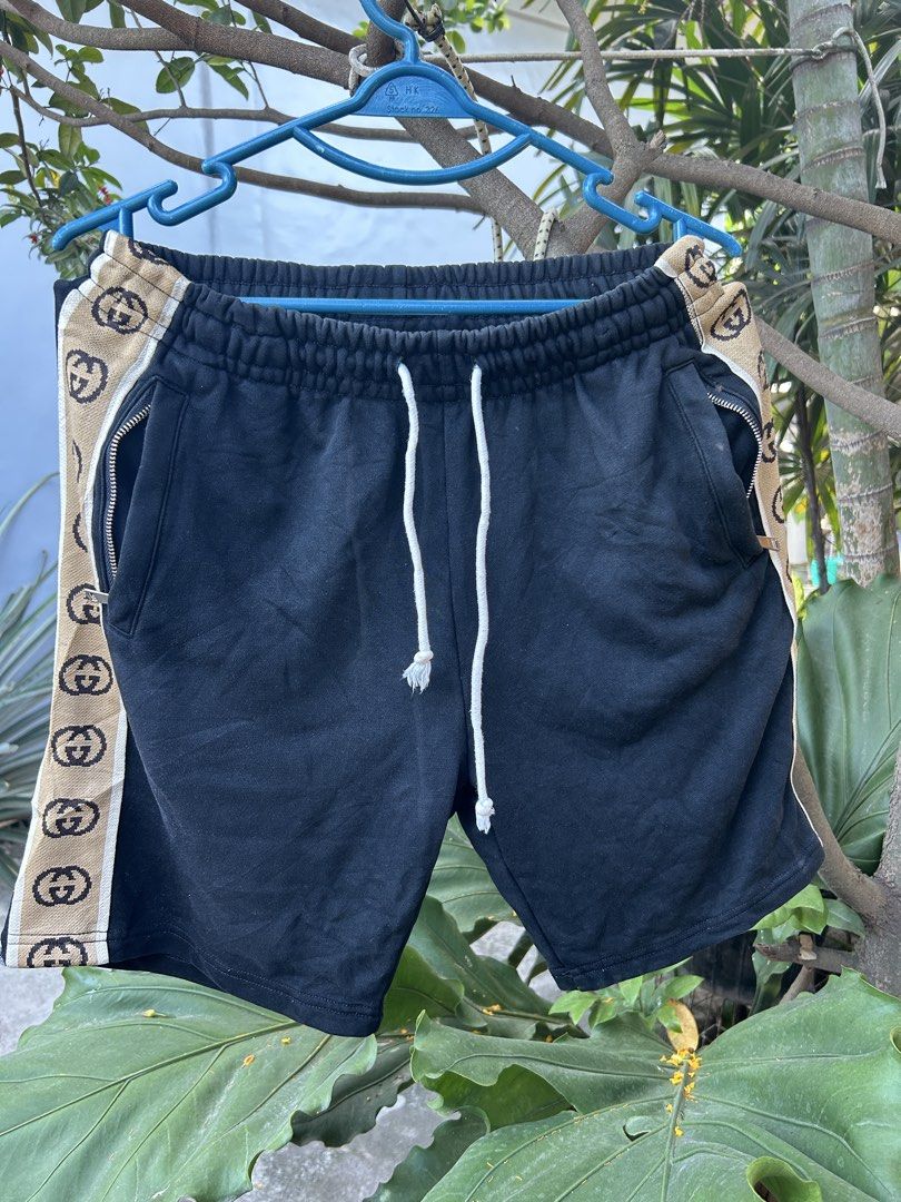 Gucci Interlocking G Side Stripe Jogging Shorts (Category: Shorts) located in Manila. Submitted by andotputla37237 (Listing ID 1470349036, Image 1). Description: - Brand: Designer (Made in Italy) - Size: S (Relaxed fit) - Material: Heavyweight black cotton fleece - Details: Beige & brown GG interlocking stripe tape on both sides - Features: White drawstring waistband & secure zip pockets on each side.