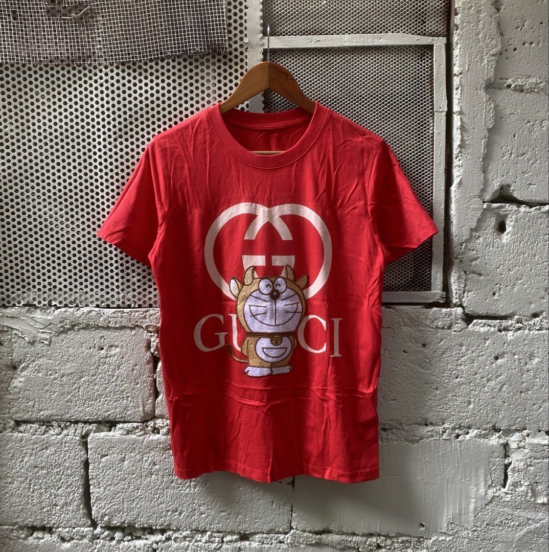 GUCCI x DORAEMON (Category: Shirts) located in Manila. Submitted by aym_fortunate (Listing ID 1470241864, Image 1). Description: EXCELLENT CONDITIN. DIMES. WIDTH : 20 LENGTH : 26 SIZE : MEDIUM COLOR RATE / CONDITION : 9/10 ISSUE : NO NECK TAG.