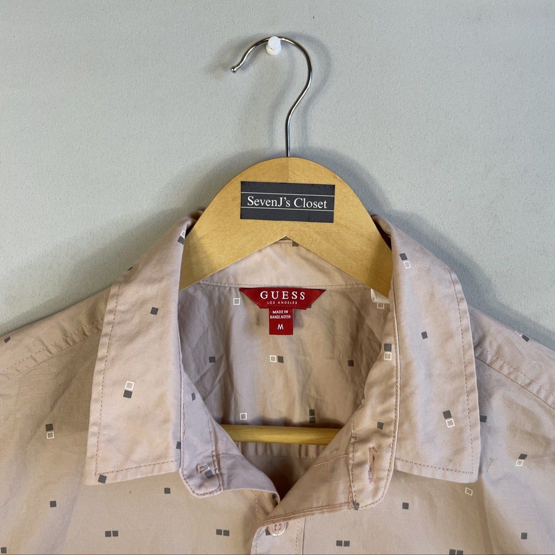 GUESS | Beige-Tan Geometric Micro-Print Button-Down Shirt (Category: Tshirts & Polo Shirts ) located in Norzagaray. Submitted by sevenjscloset (Listing ID 1470272591, Image 2). Description: - Brand: GUESS - Color: Beige-tan with geometric micro-print - Size: Medium (Length: 26.5", Width: 18.5") - Model Reference: 5’10” height , 70kg weight - Details: Short sleeves, front button closure, single chest pocket - Condition: 10/10, clean and zero visib