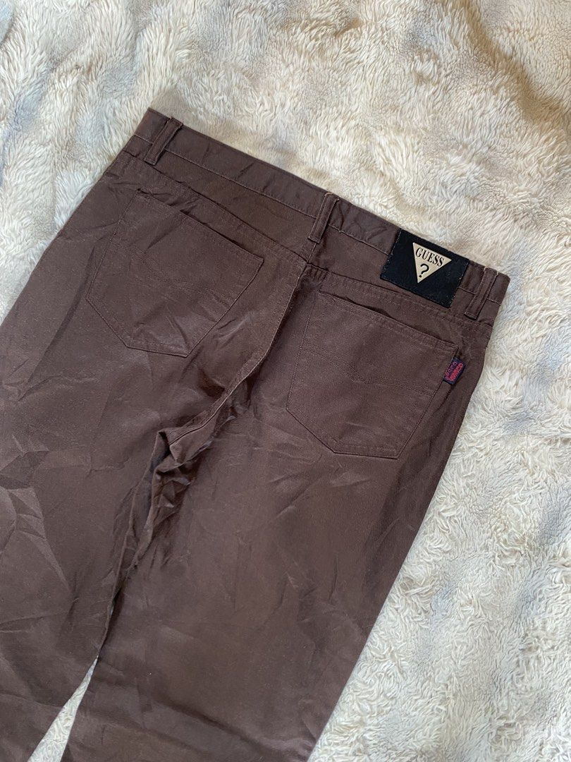 Guess Club Brown Pants (Category: Jeans) located in Andop. Submitted by safewater-895a (Listing ID 1470281012, Image 3). Description: - Brand: Guess Club - Style: Classic straight leg pants - Color: Solid brown - Details: Iconic Guess triangle metal logo patch on back waistband & red Guess Club tag on rear pocket - Closure: Standard button and zip fly with belt loops - Condition: Great staple piece for casual outfits - Waistline: 32-33 - Lenght: 