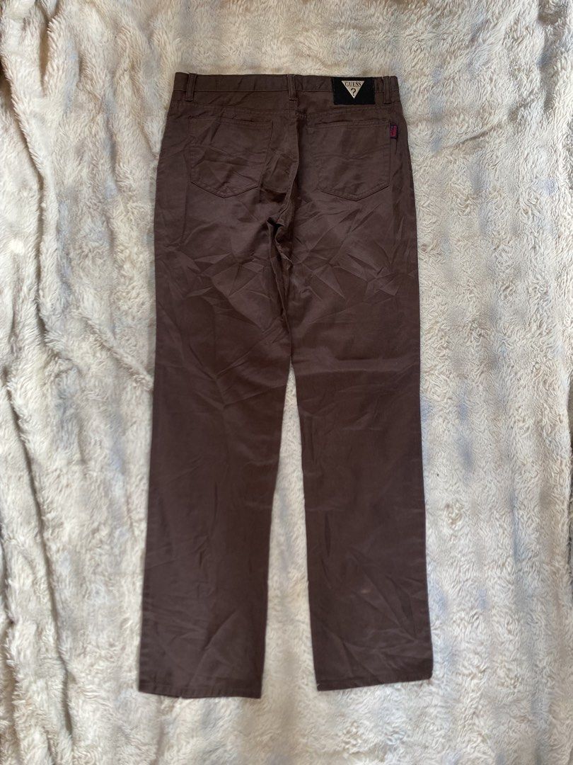 Guess Club Brown Pants (Category: Jeans) located in Andop. Submitted by safewater-895a (Listing ID 1470281012, Image 2). Description: - Brand: Guess Club - Style: Classic straight leg pants - Color: Solid brown - Details: Iconic Guess triangle metal logo patch on back waistband & red Guess Club tag on rear pocket - Closure: Standard button and zip fly with belt loops - Condition: Great staple piece for casual outfits - Waistline: 32-33 - Lenght: 