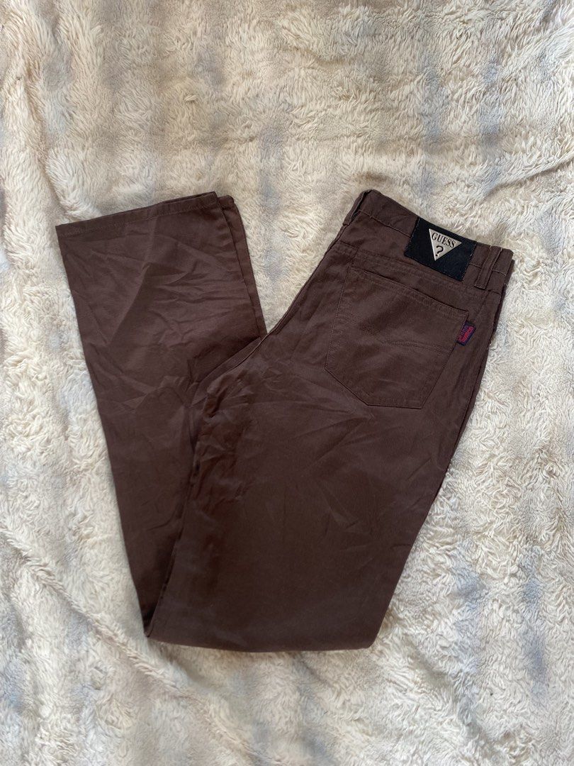 Guess Club Brown Pants (Category: Jeans) located in Andop. Submitted by safewater-895a (Listing ID 1470281012, Image 1). Description: - Brand: Guess Club - Style: Classic straight leg pants - Color: Solid brown - Details: Iconic Guess triangle metal logo patch on back waistband & red Guess Club tag on rear pocket - Closure: Standard button and zip fly with belt loops - Condition: Great staple piece for casual outfits - Waistline: 32-33 - Lenght: 