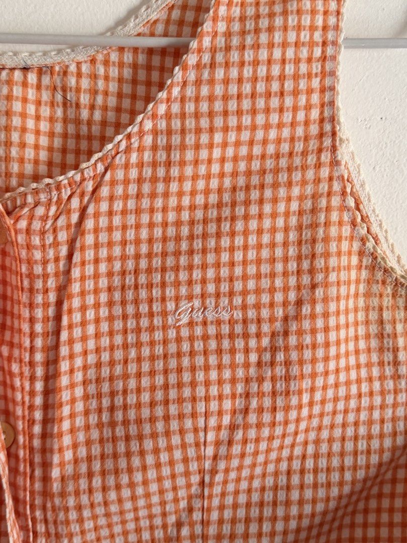 GUESS Orange Gingham Check Sleeveless button down (Category: Sleeveless) located in Imus. Submitted by dayseasons (Listing ID 1470200607, Image 2). Description: - Sleeveless button-down tank top with curved hem - with delicate white lace trim and embroidered cursive logo on chest - Material: Lightweight, breathable cotton .