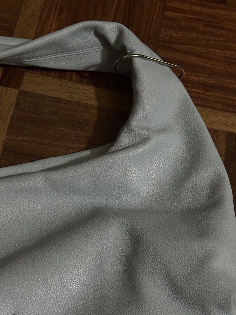 GVN Medium Light Hobo Bag (Category: Shoulder Bags) located in Davao. Submitted by fashiondeclutter11 (Listing ID 1470238623, Image 3). Description: - Brand: Gvn - Color: Light blue - Material: Pebbled faux leather with silver-tone hardware - Closure: Zippered top with stylish ring detail on the strap - Interior: Cream-colored lining with an extra zippered pocket - Design: Roomy everyday hobo shape that fits all daily essentials - in very very go