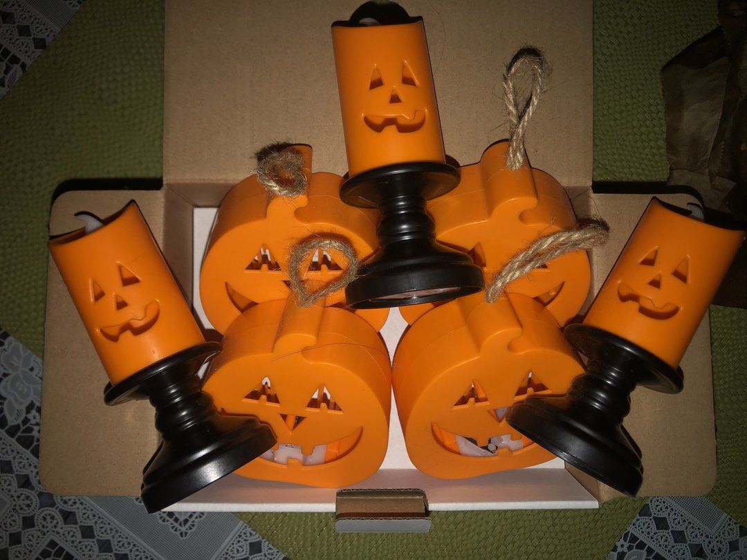 Halloween Decor Set (Category: Lighting) located in Angeles City. Submitted by bratzdylan (Listing ID 1470155858, Image 1). Description: - Complete 7-piece Halloween decor bundle in orange and black - Includes 4 flat pumpkin shapes with jute string hangers for easy hanging - Includes 3 tall jack-o'-lantern candle holders on sturdy black bases - Comes neatly packed in a cardboard storage box for easy off-season storage - Great mix of tabletop and 
