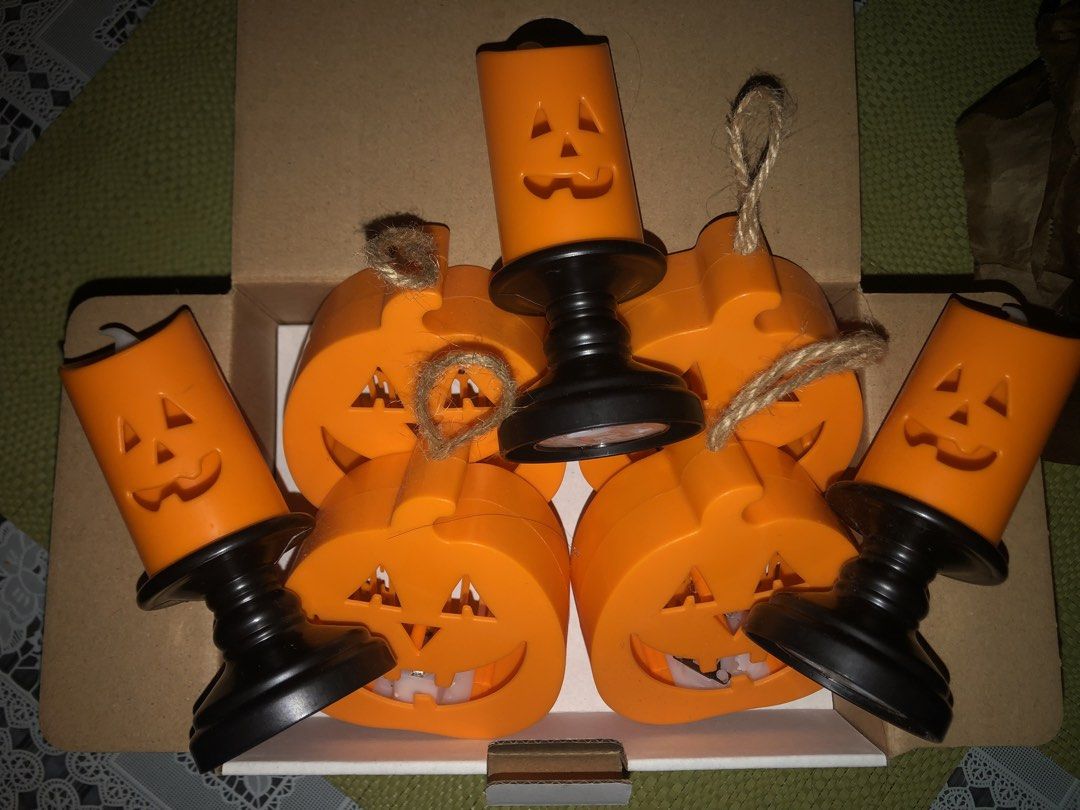 Halloween Decor Set (Category: Lighting) located in Angeles City. Submitted by bratzdylan (Listing ID 1470155858, Image 2). Description: - Complete 7-piece Halloween decor bundle in orange and black - Includes 4 flat pumpkin shapes with jute string hangers for easy hanging - Includes 3 tall jack-o'-lantern candle holders on sturdy black bases - Comes neatly packed in a cardboard storage box for easy off-season storage - Great mix of tabletop and 