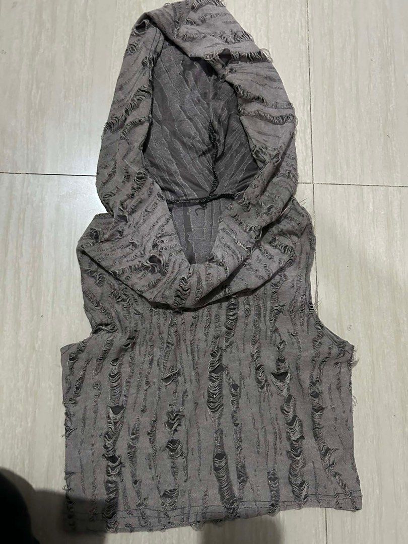 Gray tank top (Category: Sleeveless) located in Manila. Submitted by lovely.453 (Listing ID 1470234840, Image 1). Description: - Color: Dark grey - Style: Edgy, grunge sleeveless hooded top - Design: Unique layered cowl neck hood - Details: Heavy horizontal shredded details and intentional ladder rips all over - Finish: Raw cut armholes and hem - Material: Lightweight and comfortable.