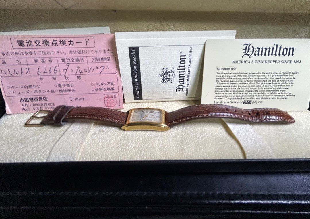 Hamilton rectangular gold dress watch with leather strap (Category: Luxury Watches) located in Manila. Submitted by japanarchivefinds (Listing ID 1470224322, Image 3). Description: - Brand: Hamilton rectangular dress watch - Color: Gold-tone polished case with silver dial and Roman numerals - Features: Small seconds sub-dial at 6 o'clock and battery-operated quartz movement - Strap: Brown lizard grain leather strap with pin buckle - Condition: Cl